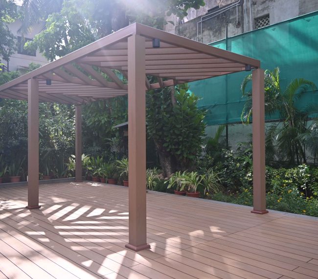 Pergola and deck made with Everwood WPC materials in a garden setting.